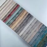Warp knitted embossed printed velvet upholstery with nonwoven backing